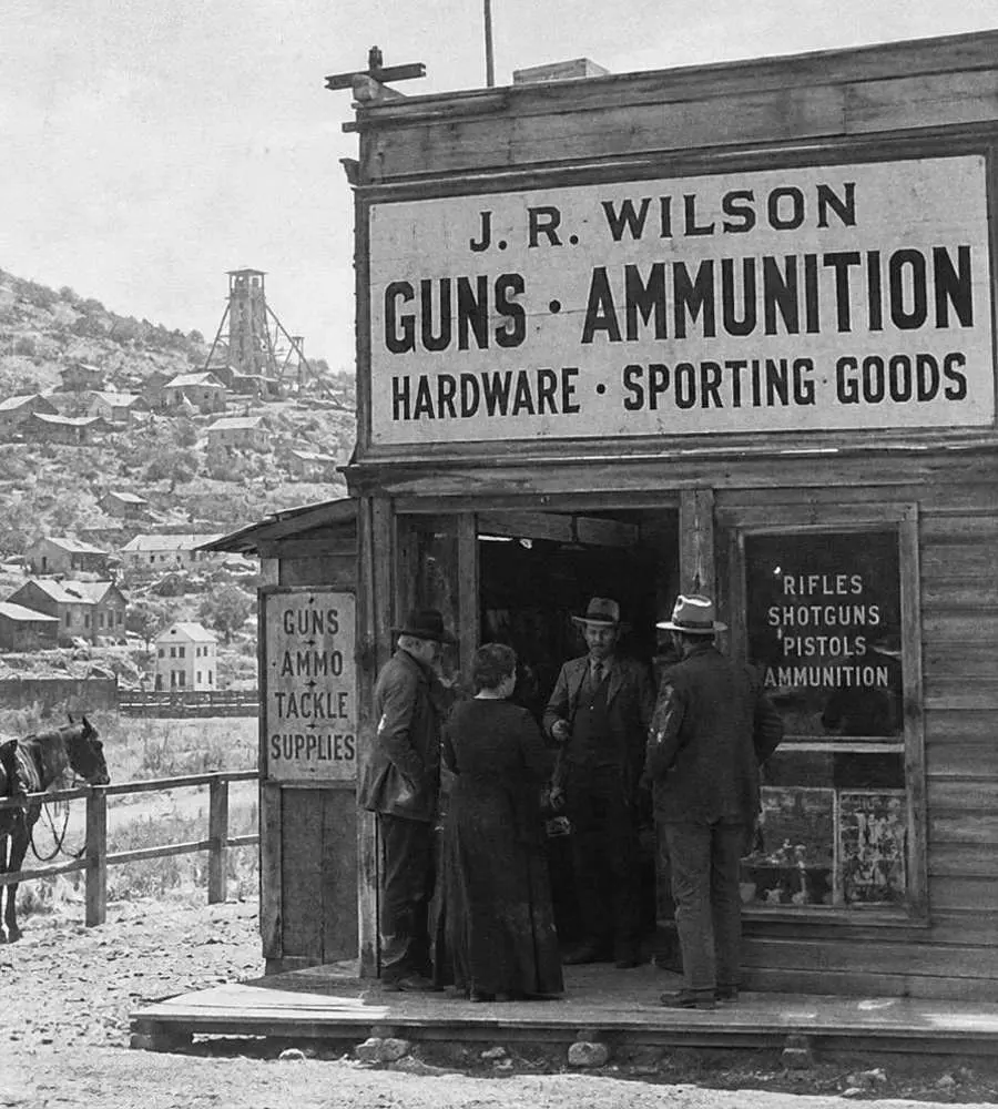 Archival black and white photograph of a small family gun shop in Arizona